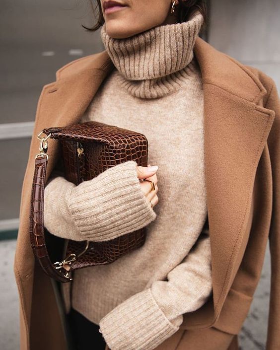 woman in sweater, coat, and holding a bag for Camel Outfits