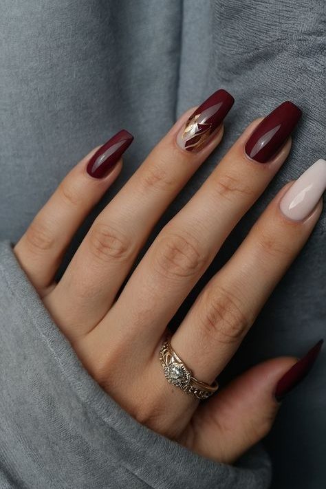 Glossy Burgundy Nails with Gold Accents